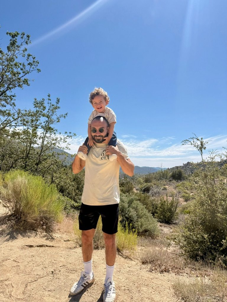 Saad El-Hajjaoui hiking with his son on his shoulders