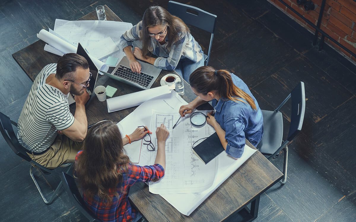 Back-office team working through paperwork at a desk