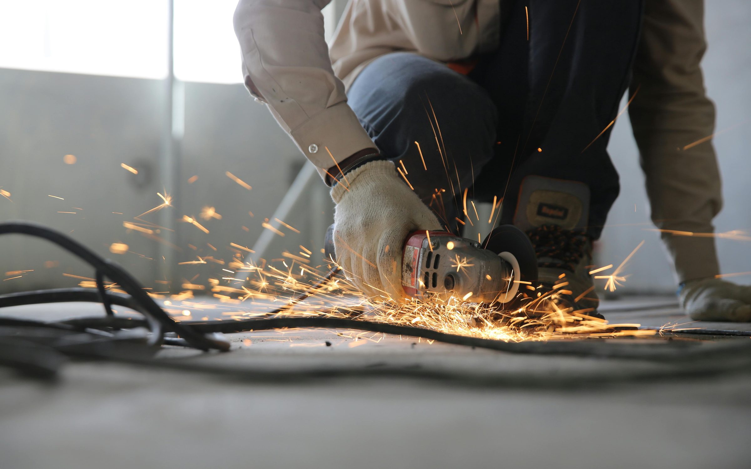 Angle grinder throwing sparks on a construction site